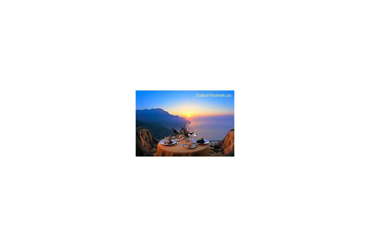 Romantic sunset dinner for two on a terrace overlooking the Amalfi Coast, with candles and fine dining.
